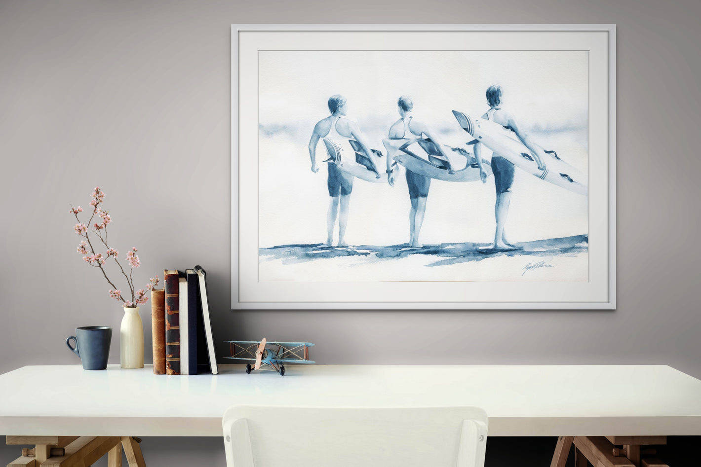 A coastal wall art watercolour painting of three surf lifesavers on the beach holding rescue boards ready to head out into the surf